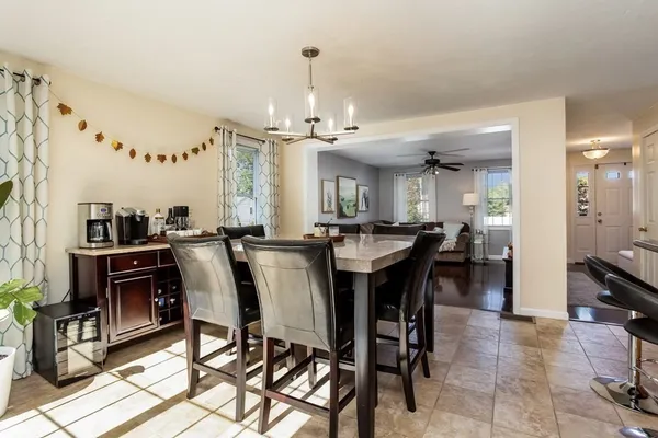 a view of a dining room with furniture and a chandelier