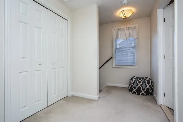 an empty room with a painting on the wall