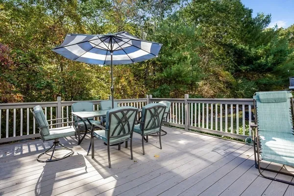 a view of balcony with wooden floor and outdoor seating
