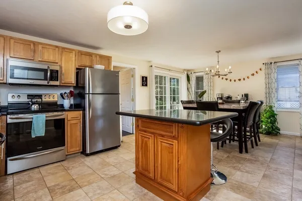 a kitchen with stainless steel appliances a refrigerator a stove a sink and a refrigerator