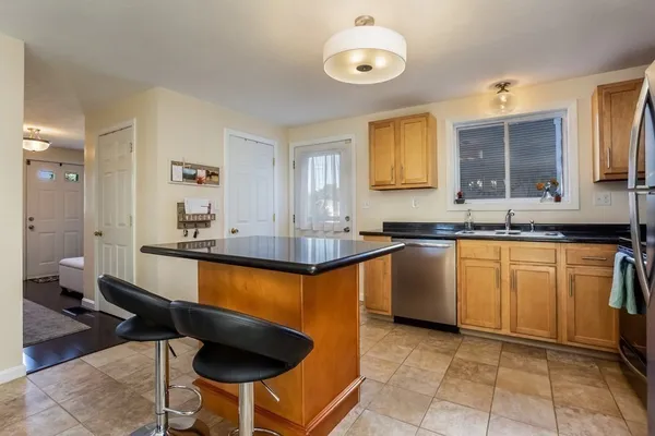 a large kitchen with granite countertop a sink and a stove