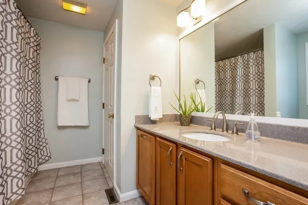 a bathroom with a double vanity sink and a mirror