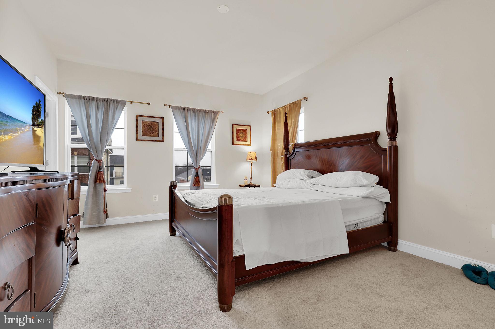 5846 Donovan Lane Ellicott City, MD 21043 - Photo 17 of 31 a bedroom with a bed chair and dresser