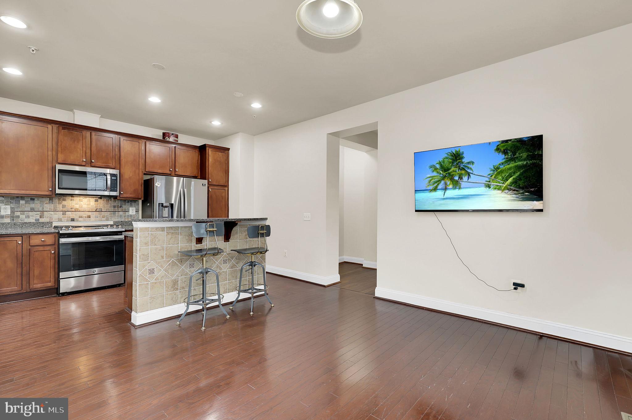 5846 Donovan Lane Ellicott City, MD 21043 - Photo 3 of 31 a view of kitchen with microwave stove refrigerator and cabinets