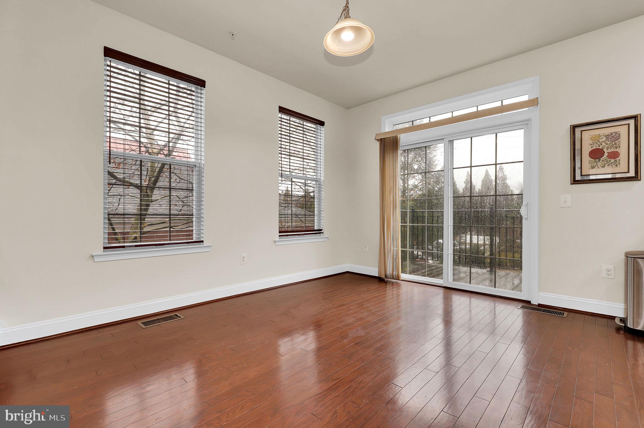 5846 Donovan Lane Ellicott City, MD 21043 - Photo 4 of 31 a view of an empty room with wooden floor and windows