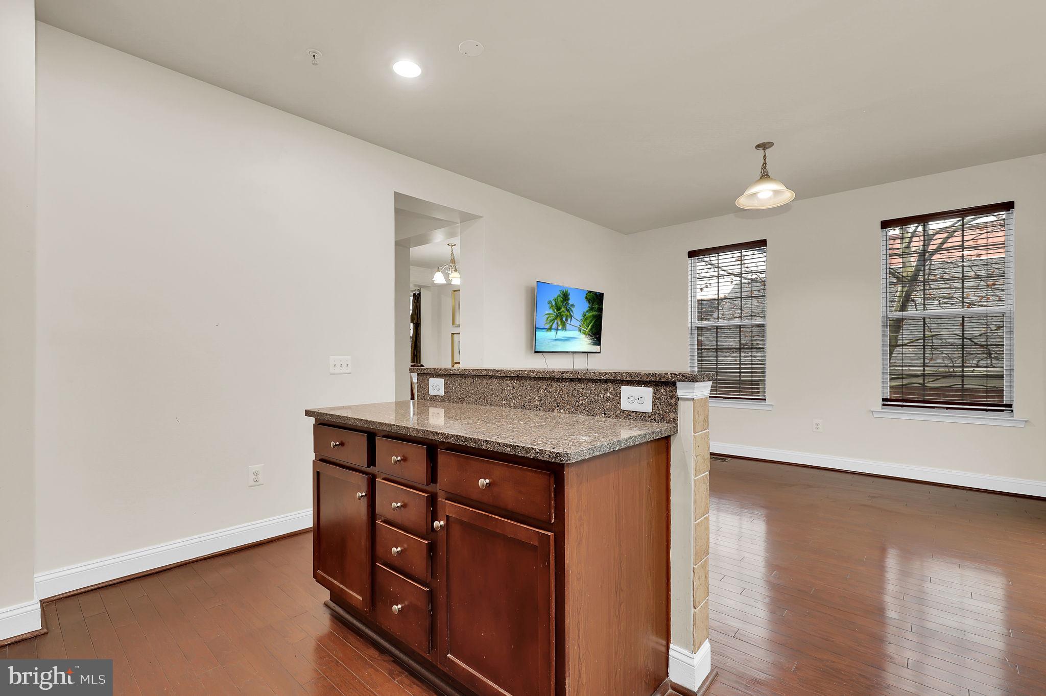 5846 Donovan Lane Ellicott City, MD 21043 - Photo 9 of 31 a kitchen with granite countertop a stove and a wooden floors