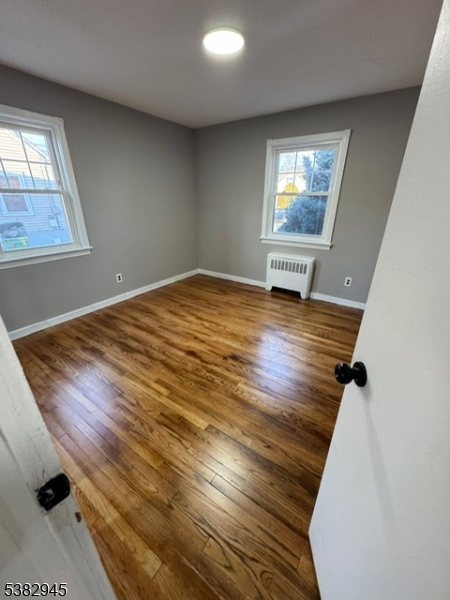 1292 Crescent Avenue Roselle, NJ 07203 - Photo 16 of 35 wooden floor in an empty room with a window