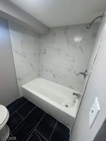 a bathroom with a bathtub and a toilet
