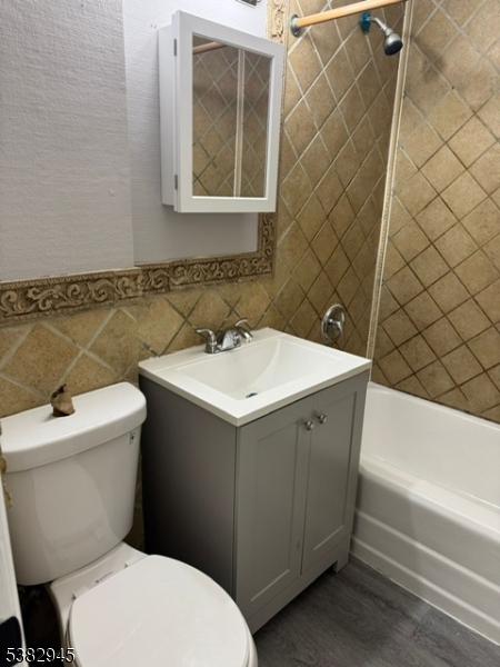 1292 Crescent Avenue Roselle, NJ 07203 - Photo 35 of 35 a bathroom with a sink mirror vanity and toilet