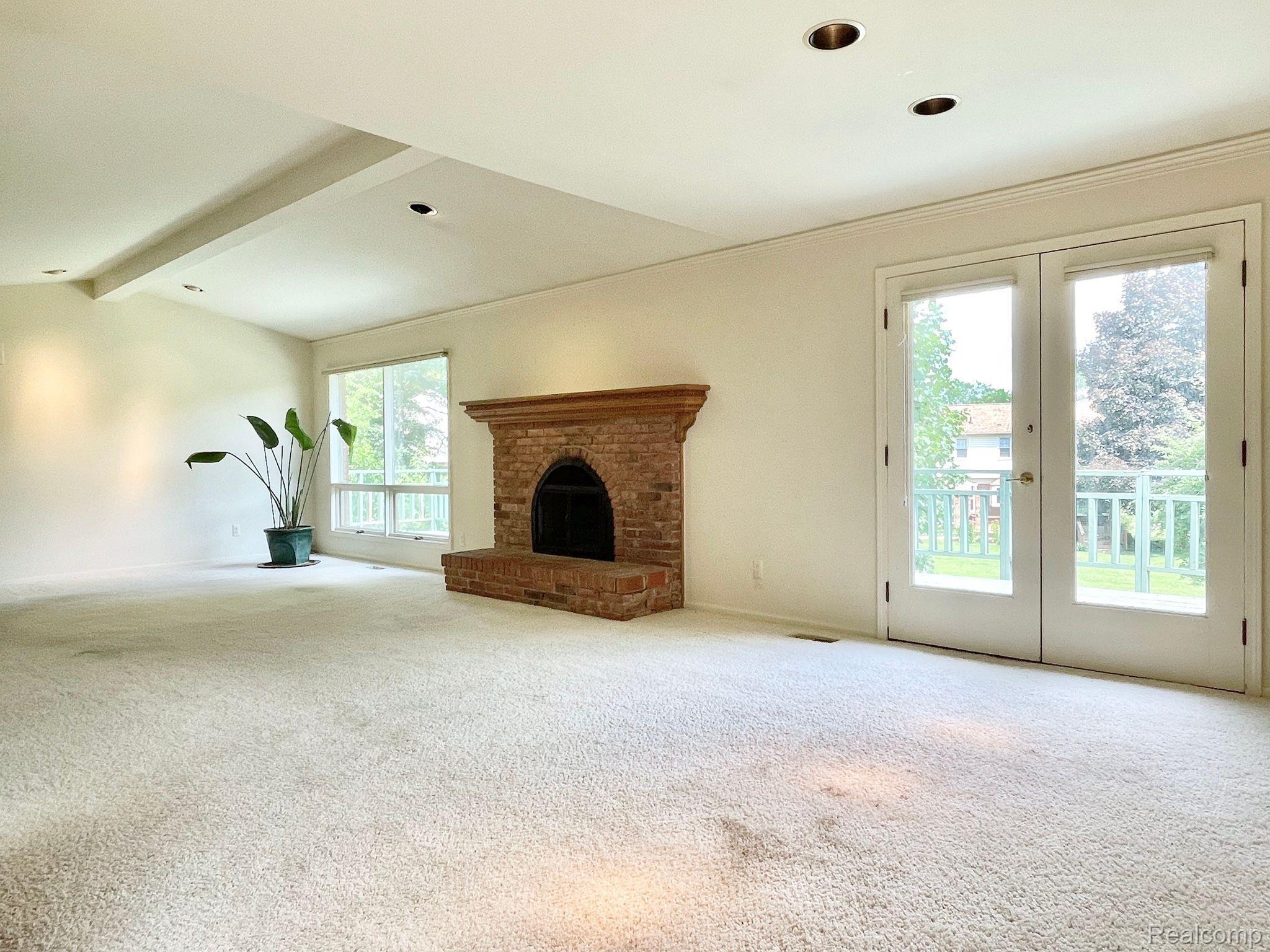 5211 Darby Circle Rochester, MI 48306 - Photo 6 of 49 Wood burning fireplace & walkout to balcony