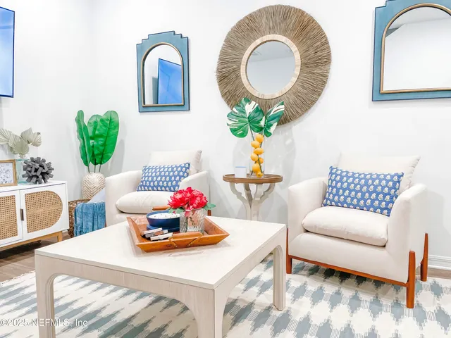 a living room with furniture and a mirror