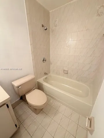 a bathroom with a toilet and a bathtub
