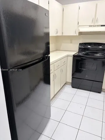 a kitchen with a stove and a refrigerator