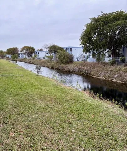 a view of a lake with houses in the back