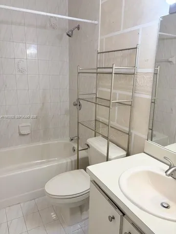 a bathroom with a toilet sink and shower