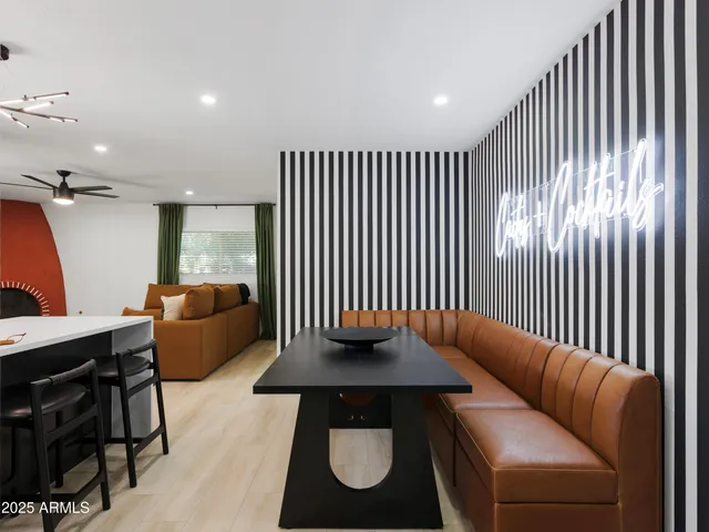 a bedroom with a large bed and a painting on the wall