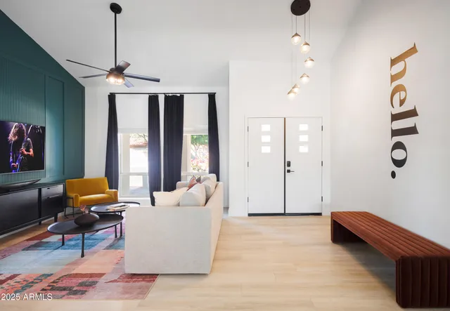 a bedroom with a large bed and a chandelier