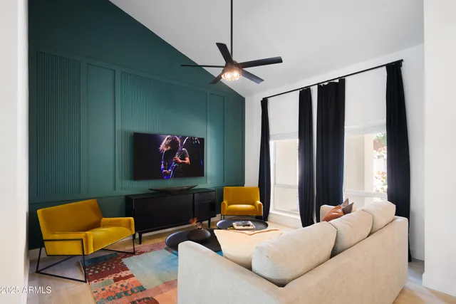a living room with furniture and a potted plant