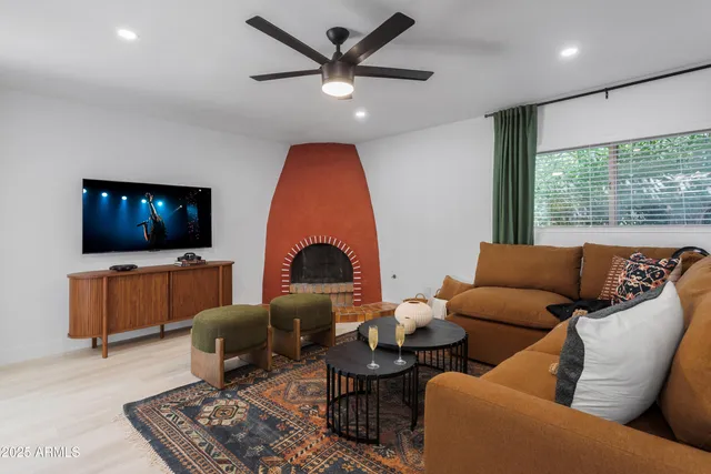 a living room with furniture a rug and a large window
