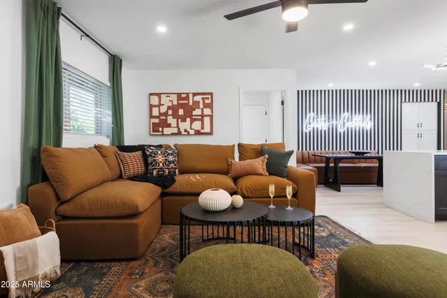 a kitchen with a stove a refrigerator a sink dishwasher a dining table and chairs with wooden floor