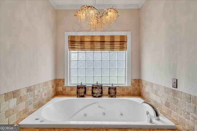 a aerial view of a house with swimming pool and large trees