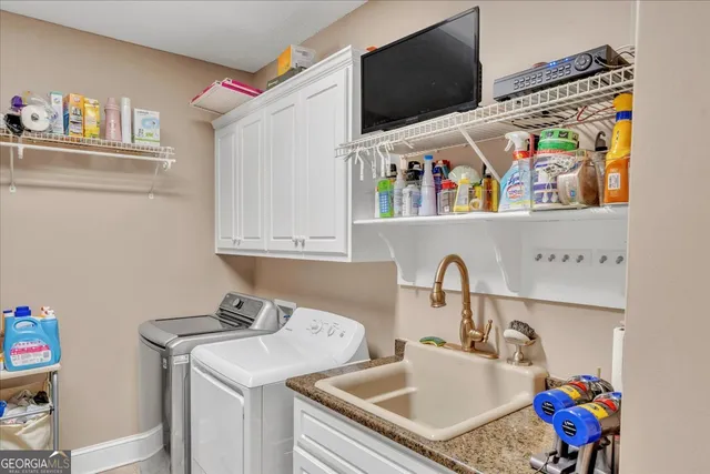 a view of a patio with table and chairs and barbeque oven