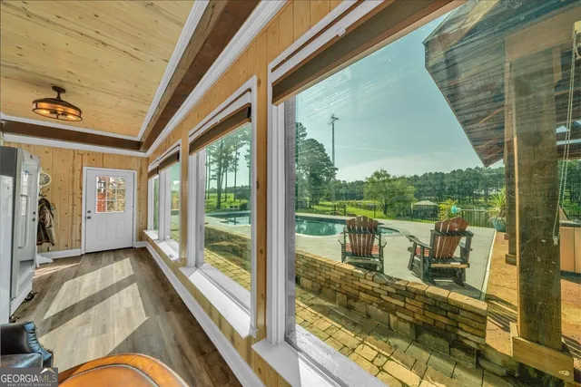 a front view of a house with a yard and potted plants