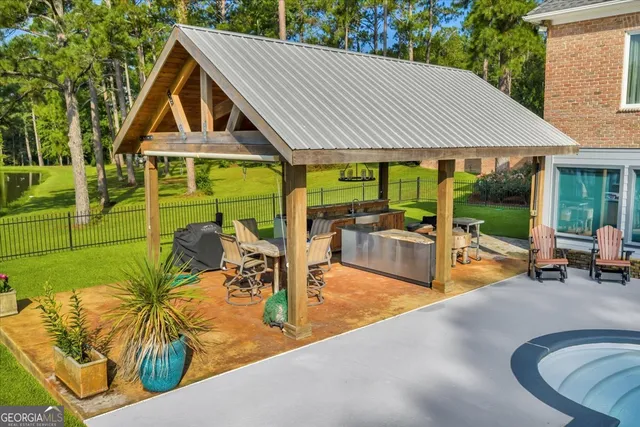 a front view of a house with swimming pool and porch