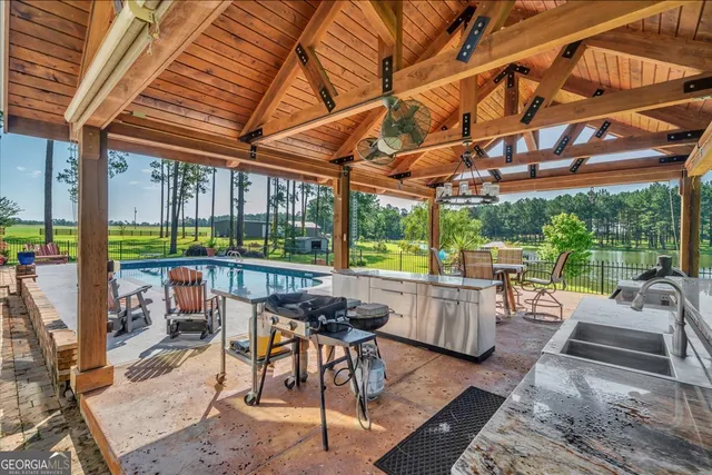 a living room with furniture a chandelier and a fireplace