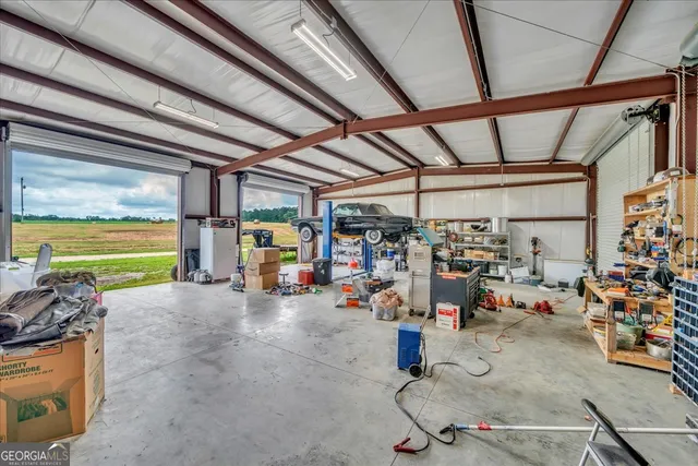 a kitchen with granite countertop a table chairs and wooden cabinets