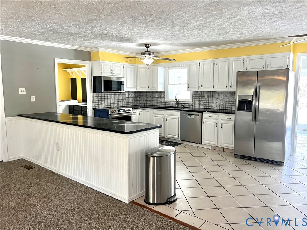 2049 Riddle Road Blackstone, VA 23824 - Photo 6 of 44 a kitchen with stainless steel appliances granite countertop a stove a sink and a refrigerator