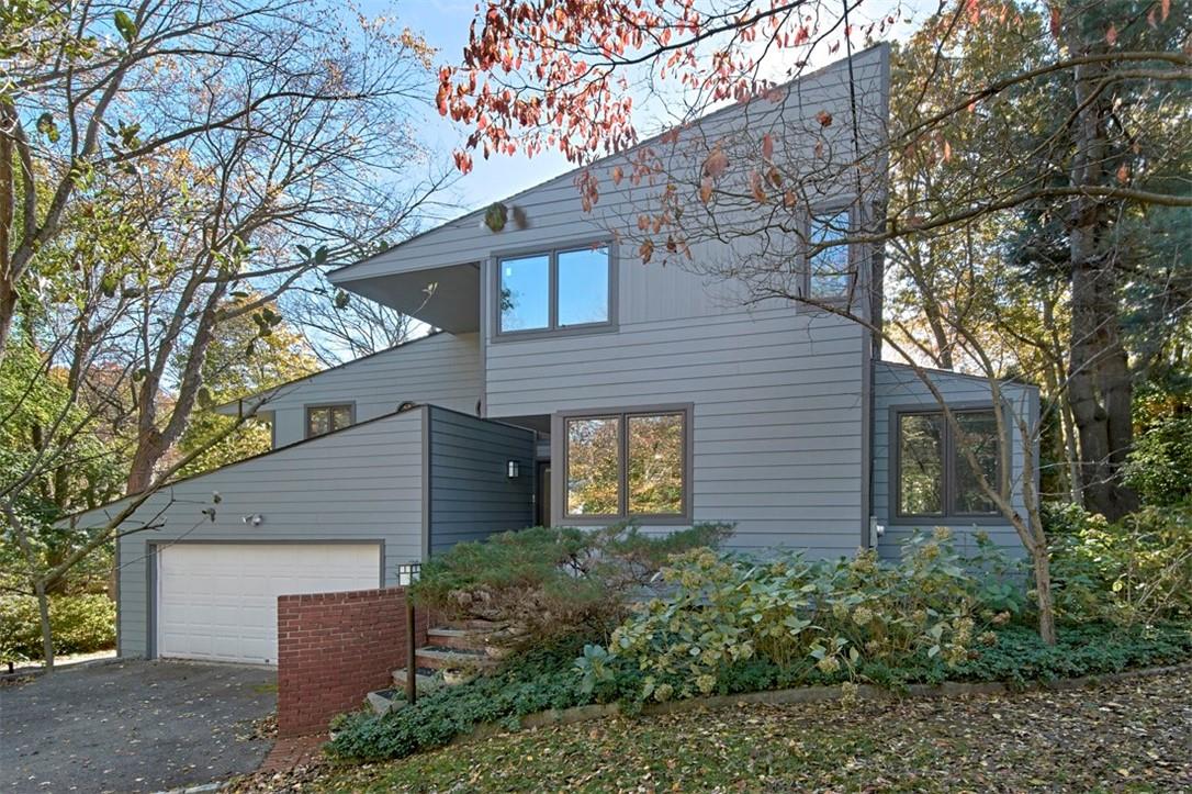 a brick house with a large tree