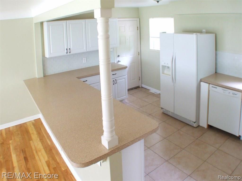 6085 Sunnydale Road Clarkston, MI 48346 - Photo 3 of 15 Breakfast bar, new white kitchen cabinets and ceramic tiled floor