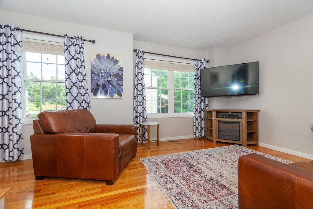 41 Boston Road, Unit 494 Billerica, MA 01862 - Photo 2 of 22 a living room with furniture and a flat screen tv