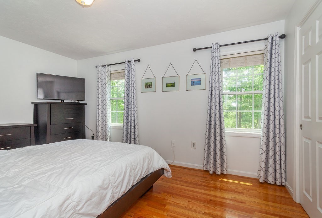 41 Boston Road, Unit 494 Billerica, MA 01862 - Photo 9 of 22 a bedroom with a bed and a flat tv screen on the dresser