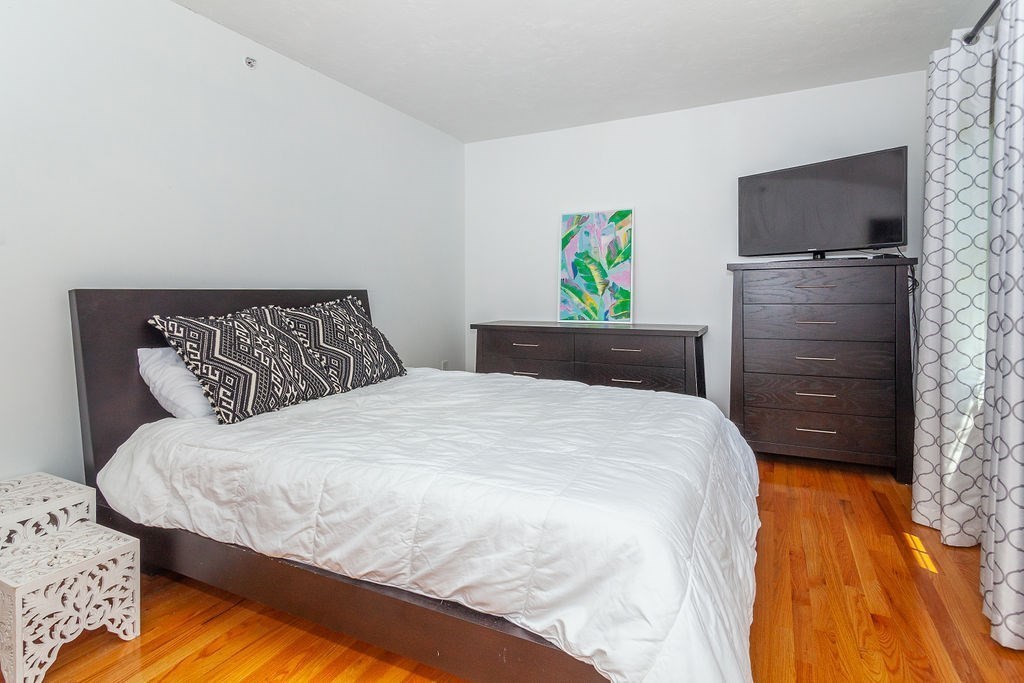 41 Boston Road, Unit 494 Billerica, MA 01862 - Photo 10 of 22 a bedroom with a bed and painting on the wall
