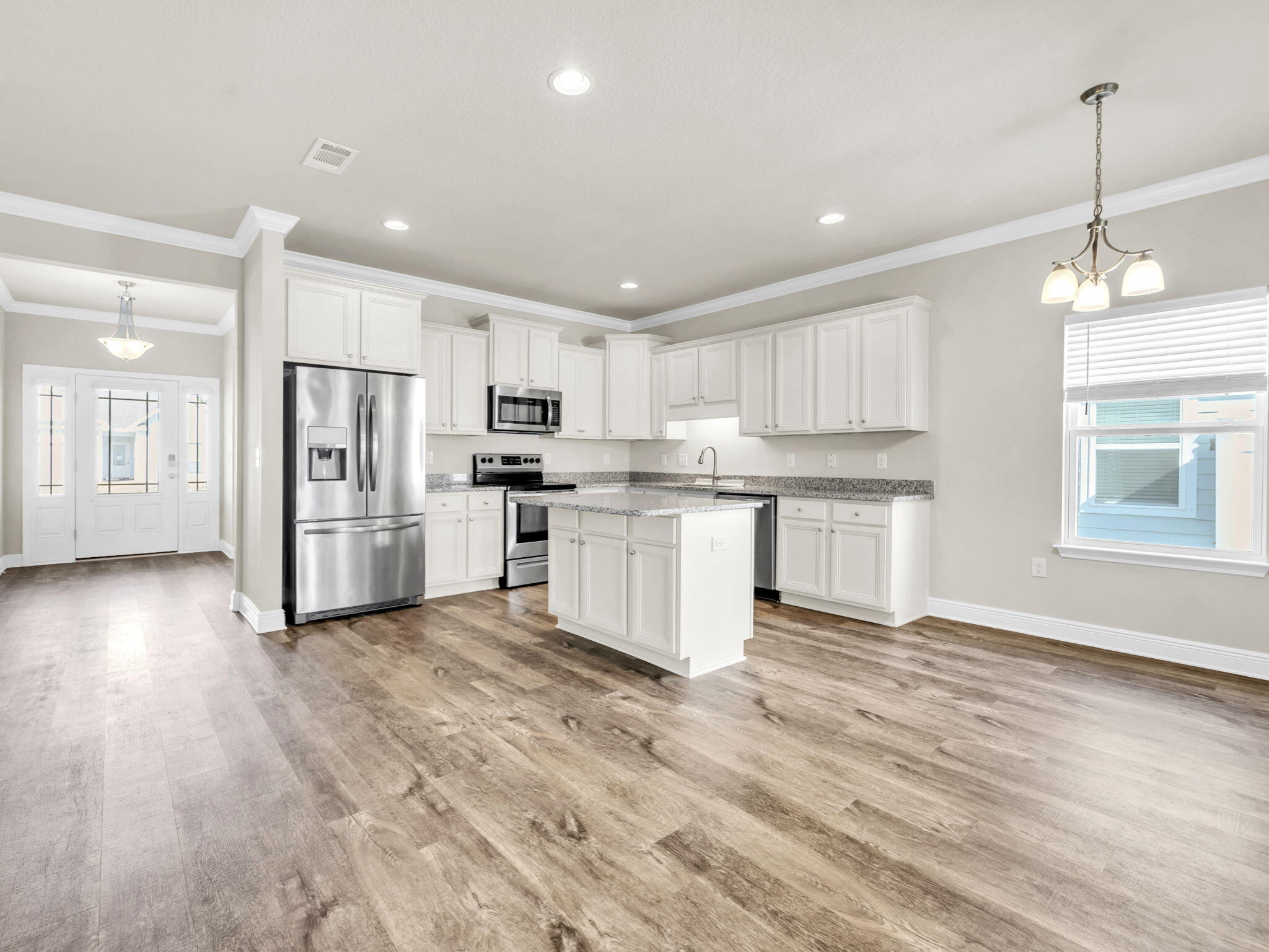 218 Stonegate Drive Santa Rosa Beach, FL 32459 - Photo 12 of 37 a kitchen with stainless steel appliances granite countertop a refrigerator a stove top oven a sink dishwasher and a refrigerator with wooden floor