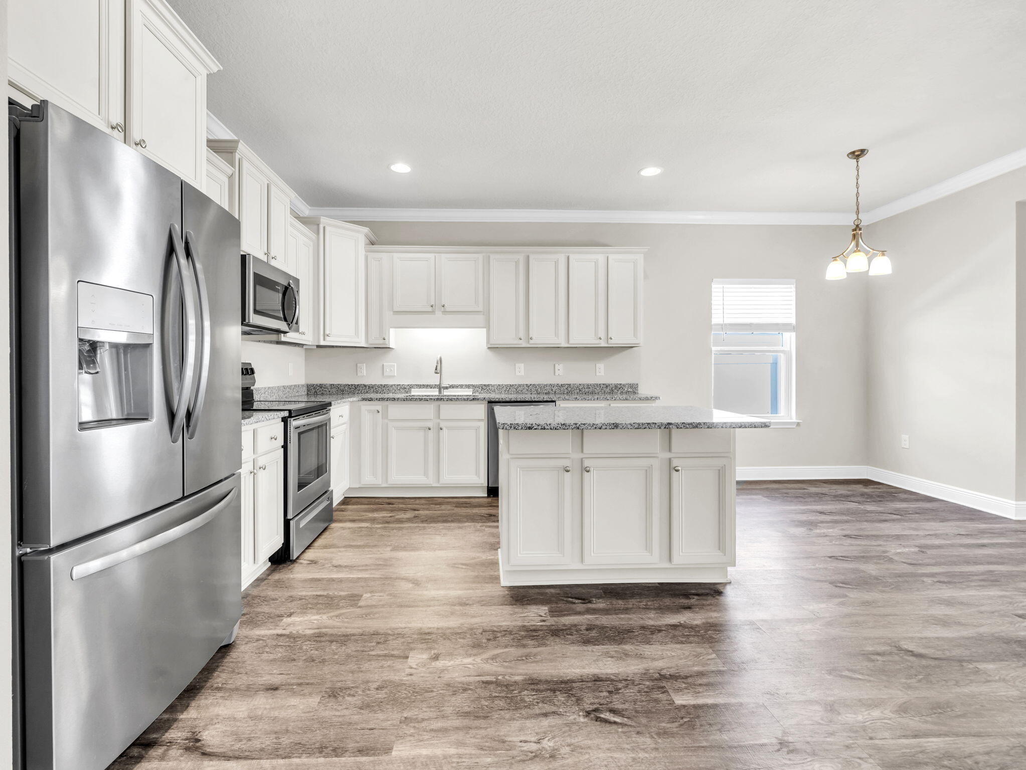 218 Stonegate Drive Santa Rosa Beach, FL 32459 - Photo 13 of 37 a kitchen with stainless steel appliances granite countertop a refrigerator sink and white cabinets