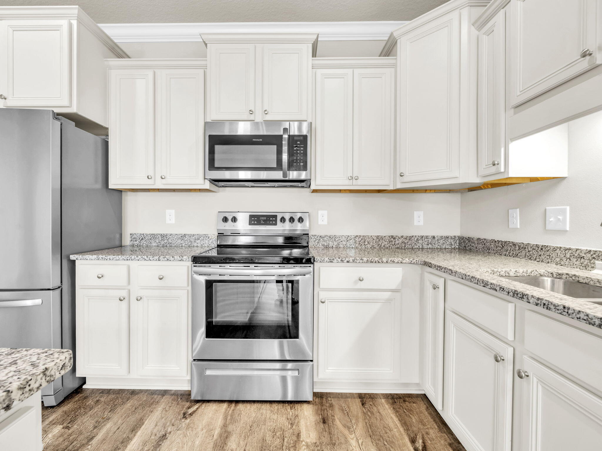 218 Stonegate Drive Santa Rosa Beach, FL 32459 - Photo 14 of 37 a kitchen with granite countertop white cabinets and stainless steel appliances