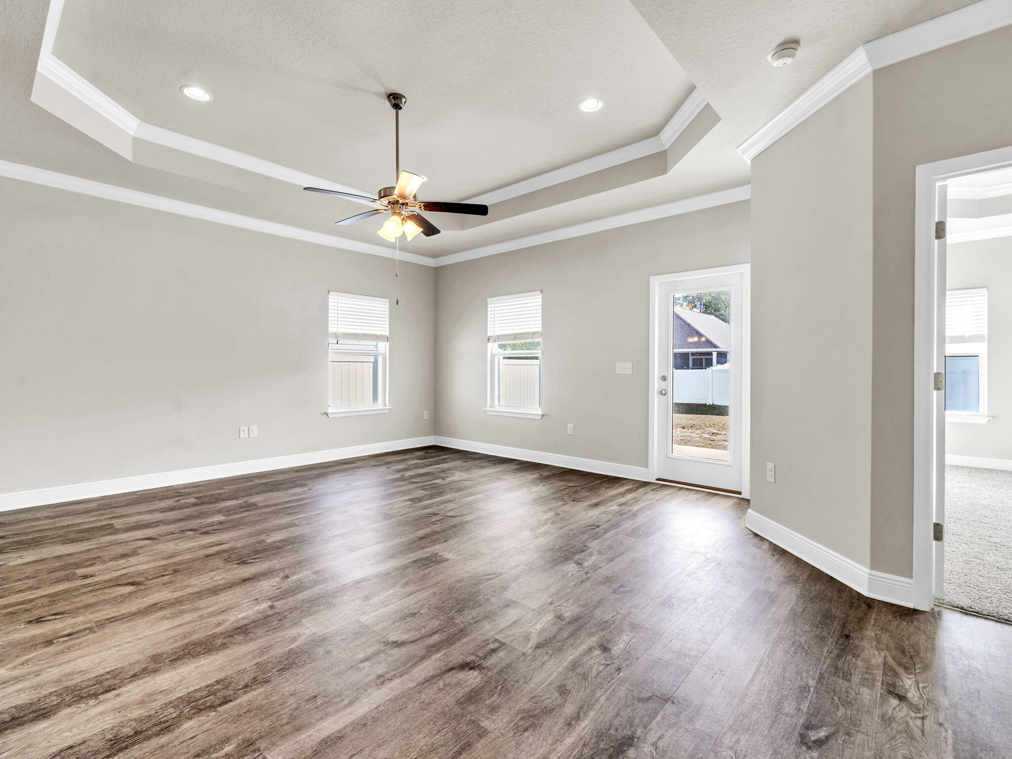 218 Stonegate Drive Santa Rosa Beach, FL 32459 - Photo 17 of 37 an empty room with wooden floor chandelier and windows