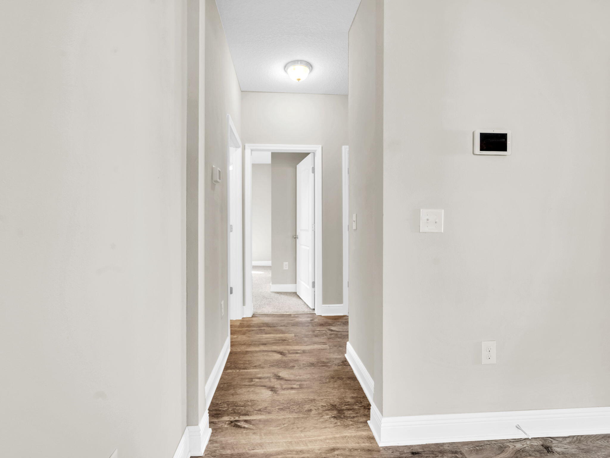 218 Stonegate Drive Santa Rosa Beach, FL 32459 - Photo 26 of 37 a view of a hallway with wooden floor