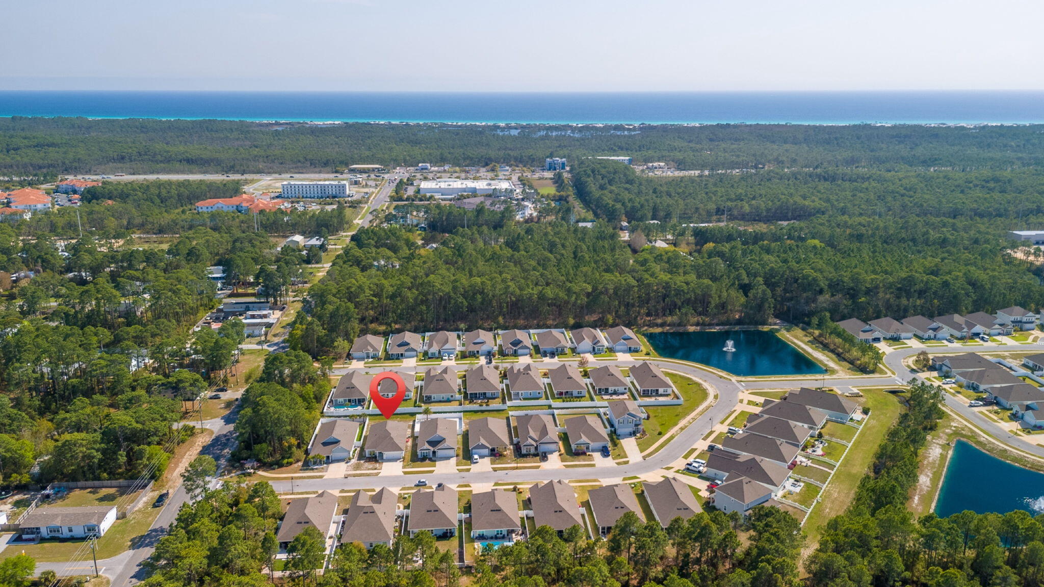 218 Stonegate Drive Santa Rosa Beach, FL 32459 - Photo 34 of 37 an aerial view of a house with a swimming pool and lake view