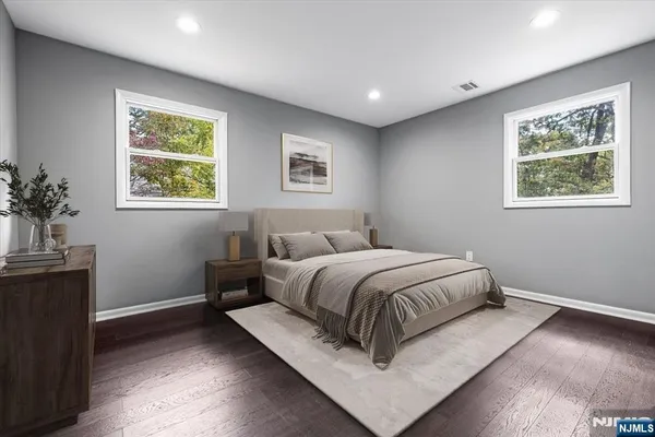 a spacious bedroom with a bed and a window