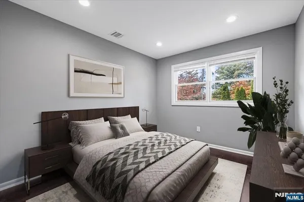 a bedroom with bed plant and window