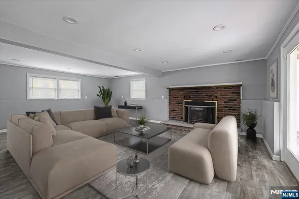 a living room with furniture fireplace and a window