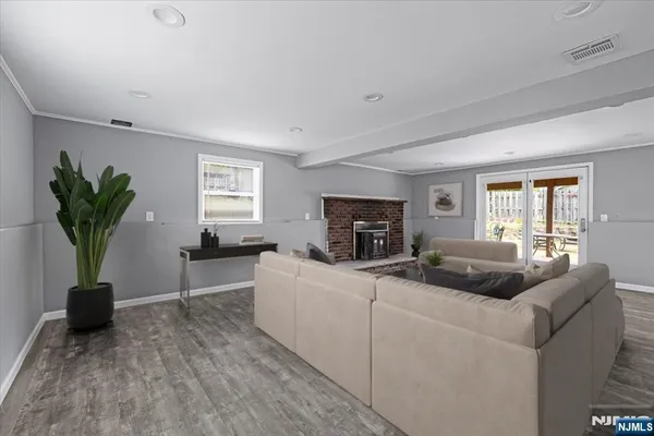 a living room with furniture a fireplace and a potted plant