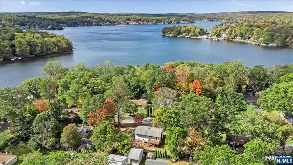 an aerial view of a houses with a lake view