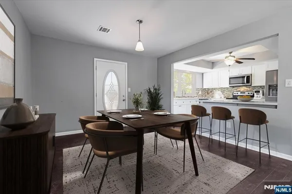 a kitchen with a dining table and chairs