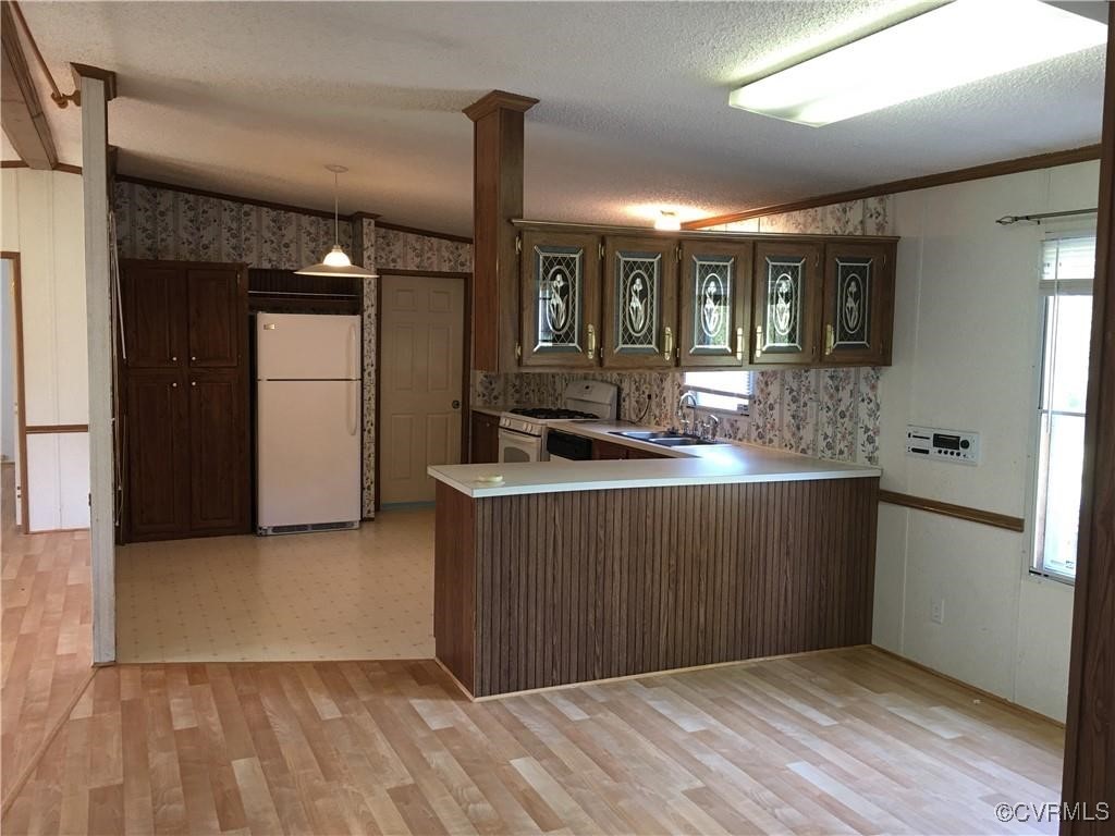 12232 Darbys Road Doswell, VA 23047 - Photo 17 of 20 a kitchen with stainless steel appliances granite countertop a sink and wooden cabinets