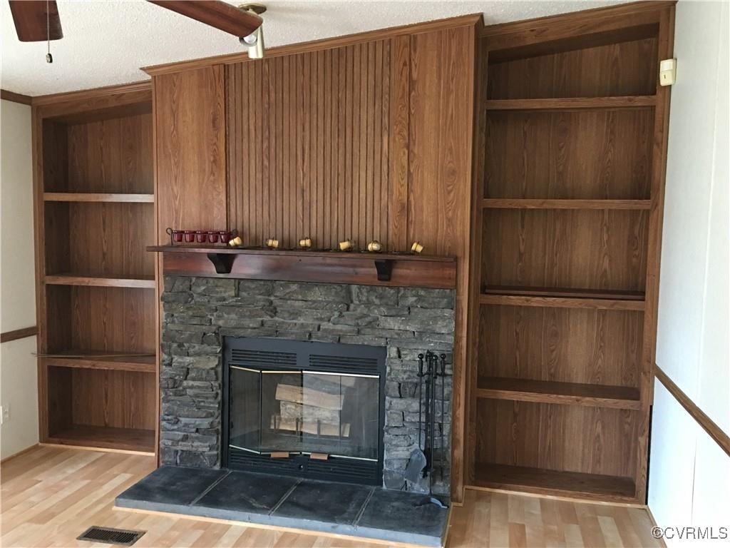 12232 Darbys Road Doswell, VA 23047 - Photo 6 of 20 a living room with a fireplace and a walk in closet